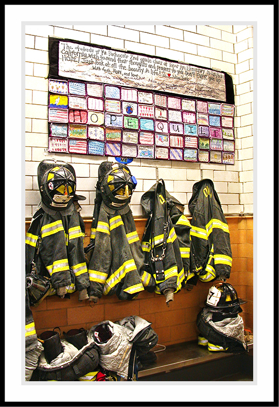 Firefighter's jackets and boots resting on a bench.